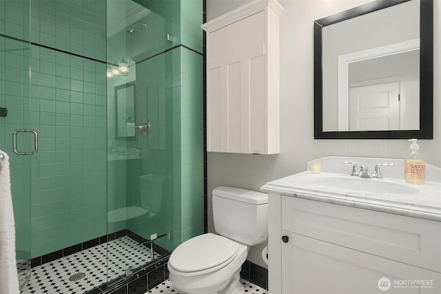 bathroom with toilet, a stall shower, and vanity