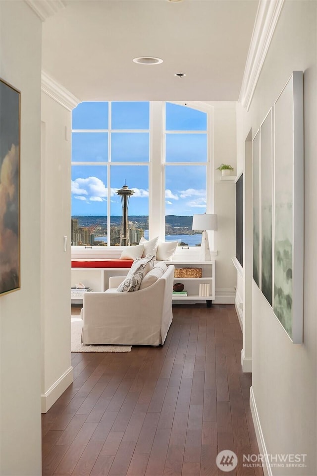 living room featuring crown molding, baseboards, and dark wood-style flooring