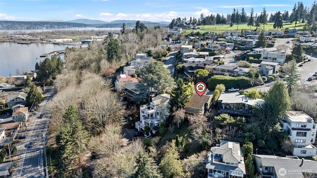 drone / aerial view featuring a residential view and a water and mountain view