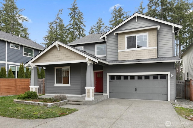 view of front of property with an attached garage, fence, driveway, and roof with shingles