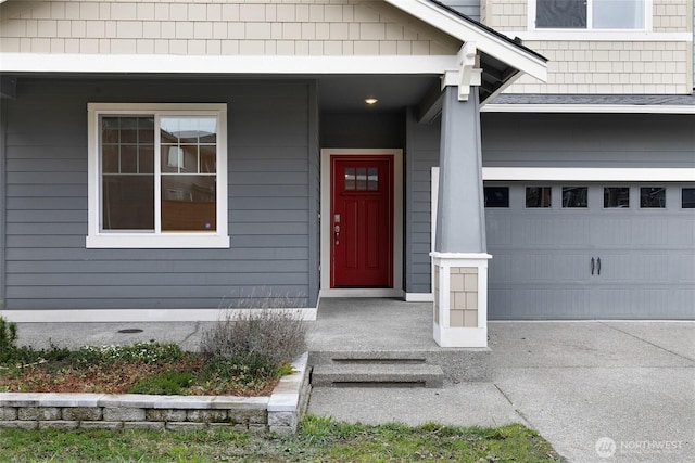 view of exterior entry featuring an attached garage and roof with shingles