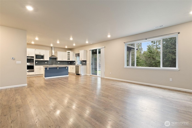 unfurnished living room featuring recessed lighting, visible vents, baseboards, and light wood-style flooring