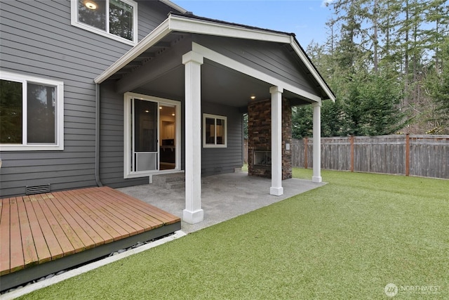 exterior space with fence and a lawn