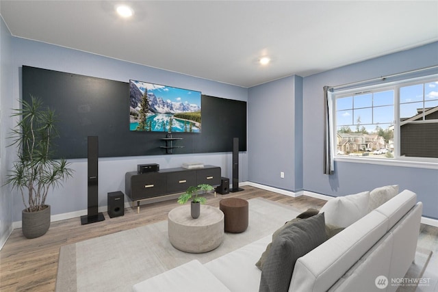 living area with recessed lighting, baseboards, and wood finished floors