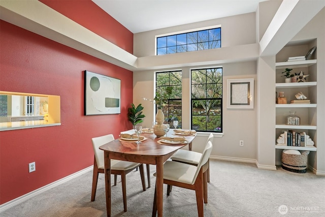 dining area with carpet floors, plenty of natural light, and built in features