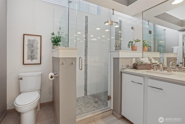 full bath featuring tasteful backsplash, toilet, a shower stall, vanity, and tile patterned floors