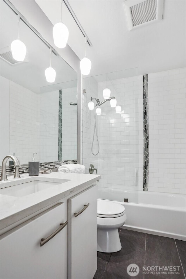 bathroom with bathtub / shower combination, toilet, tile patterned flooring, vanity, and visible vents