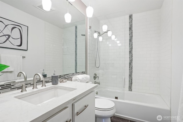 bathroom featuring visible vents, shower / bath combination, vanity, and toilet