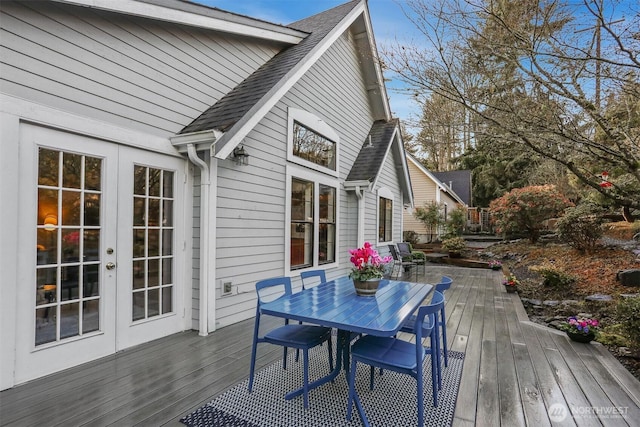 deck with outdoor dining area and french doors