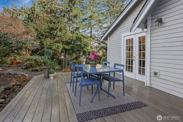 deck with french doors and outdoor dining space