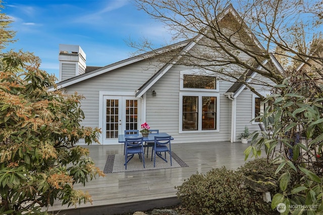 wooden deck featuring french doors and outdoor dining space