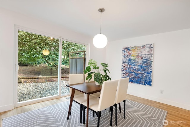 dining area featuring baseboards and wood finished floors