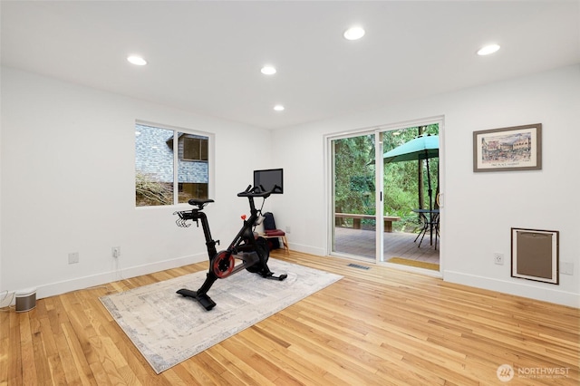 workout room with recessed lighting, visible vents, light wood finished floors, and baseboards