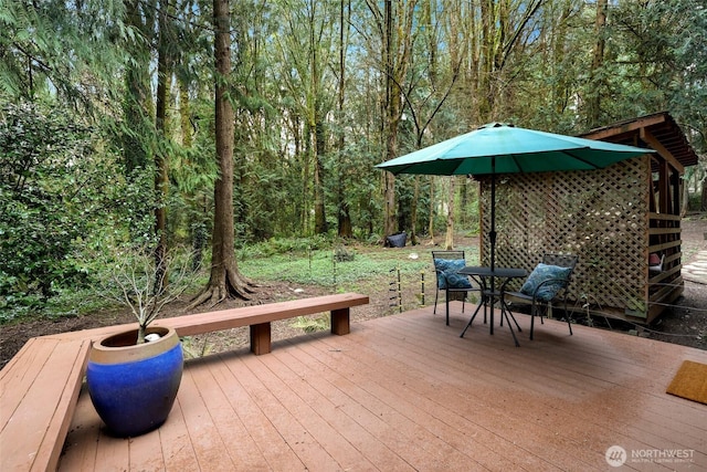 deck featuring a forest view