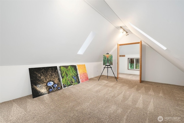 bonus room featuring lofted ceiling with skylight and carpet floors