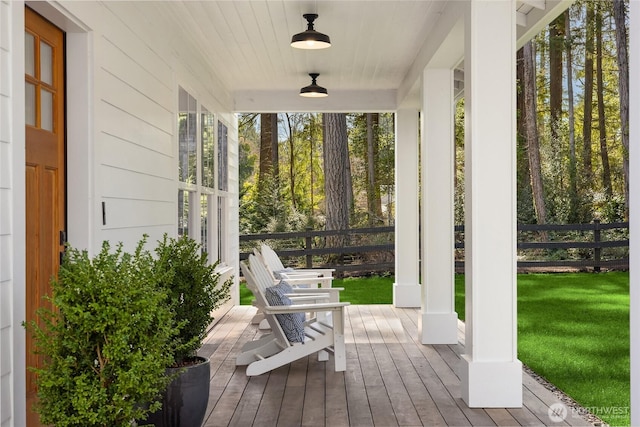 deck with a porch and a yard