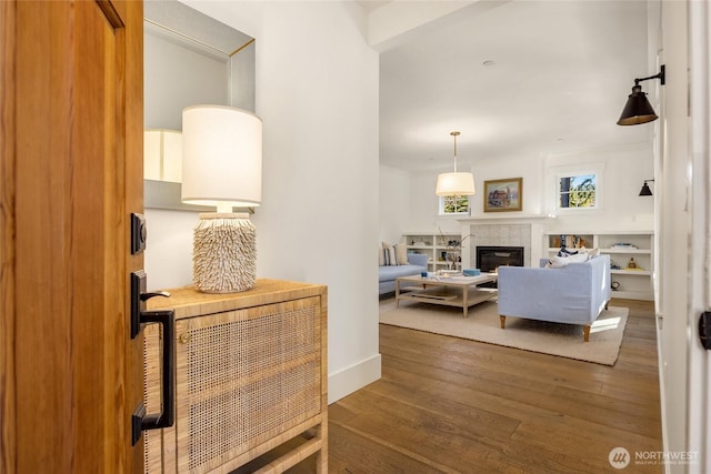 hall featuring hardwood / wood-style floors and baseboards