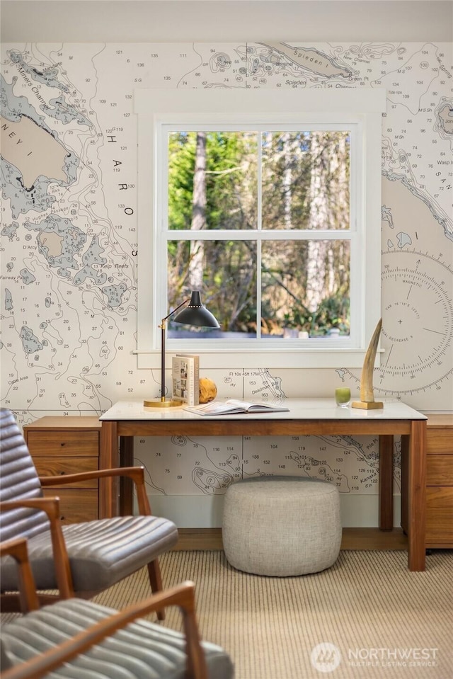 interior space with built in desk and wallpapered walls