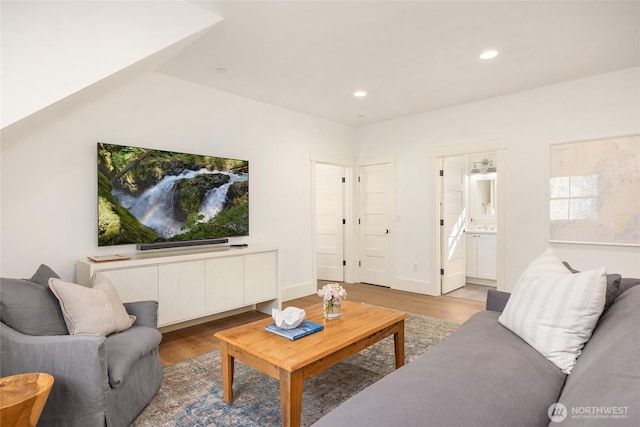 living area with recessed lighting, wood finished floors, and baseboards