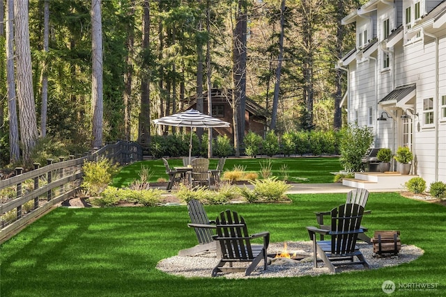 view of yard with a patio area, a fire pit, and fence