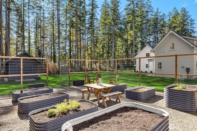 view of yard with a vegetable garden and fence