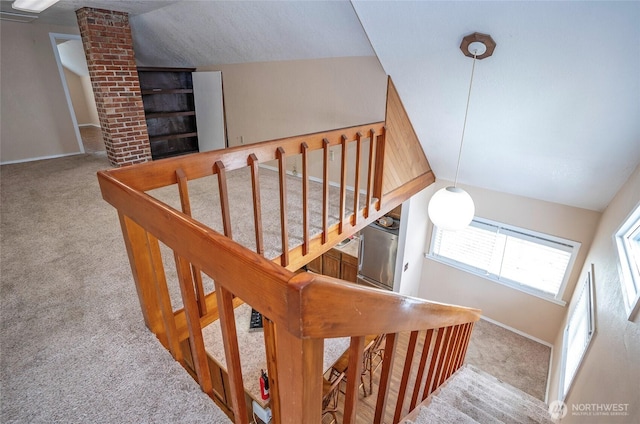 stairway with vaulted ceiling, baseboards, and carpet floors