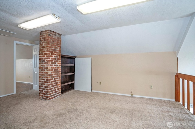 bonus room with vaulted ceiling, carpet floors, and a textured ceiling