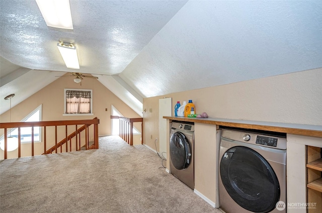 clothes washing area with carpet flooring, a textured ceiling, independent washer and dryer, and laundry area