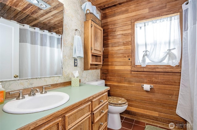 full bath featuring tile patterned floors, toilet, curtained shower, wallpapered walls, and vanity