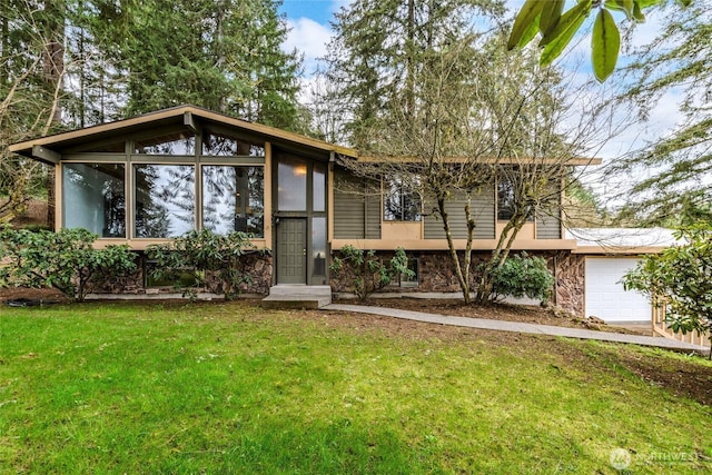 view of front of property featuring stone siding, a front yard, and a sunroom