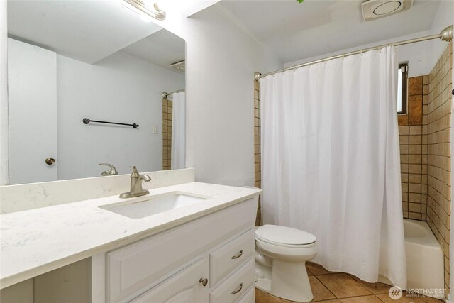 bathroom featuring vanity, tile patterned floors, toilet, and shower / tub combo with curtain