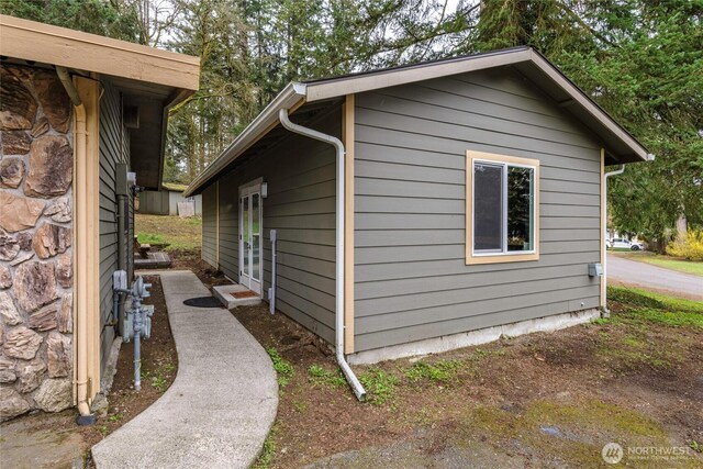 view of side of property with stone siding