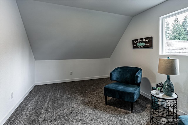 sitting room with carpet, baseboards, and vaulted ceiling