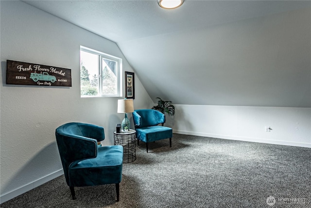 living area with vaulted ceiling, carpet flooring, and baseboards