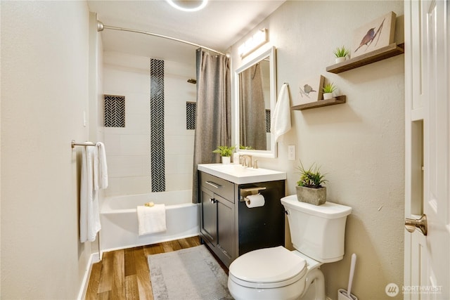 full bathroom with shower / bath combo, toilet, vanity, and wood finished floors