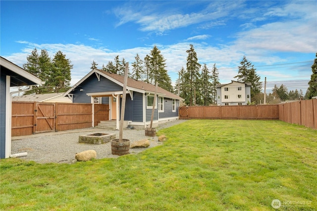 view of yard with a gate and a fenced backyard