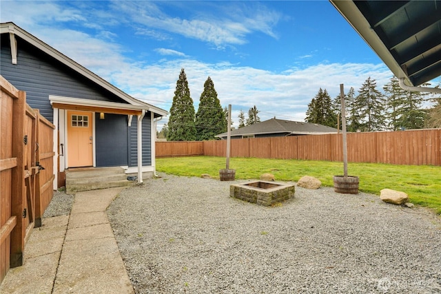 view of yard with a fire pit and a fenced backyard