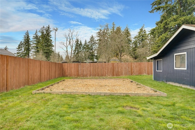 view of yard with a vegetable garden and a fenced backyard