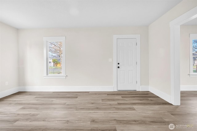 empty room with wood finished floors and baseboards