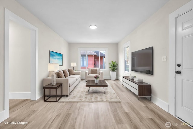 living room featuring light wood finished floors and baseboards