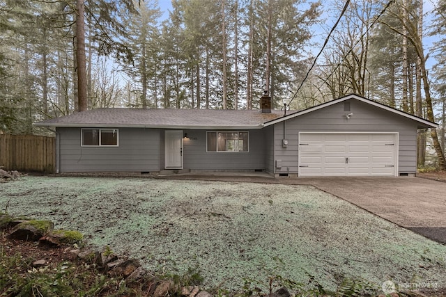 ranch-style home with a chimney, concrete driveway, an attached garage, crawl space, and fence