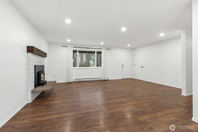 unfurnished living room featuring baseboards, baseboard heating, wood-type flooring, and recessed lighting