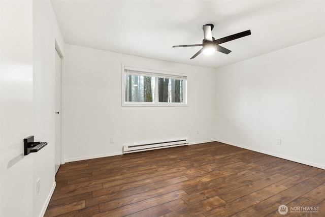 spare room featuring baseboard heating, hardwood / wood-style flooring, and a ceiling fan