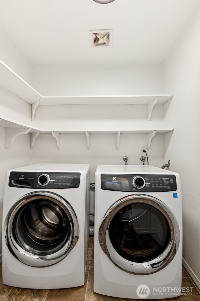 laundry room with laundry area, visible vents, and washer and dryer