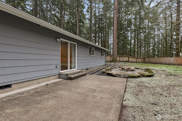 view of yard featuring entry steps, a patio area, and fence