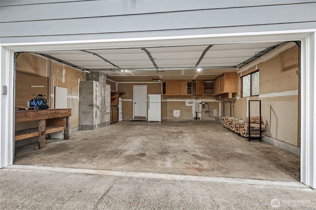 garage with electric panel and freestanding refrigerator