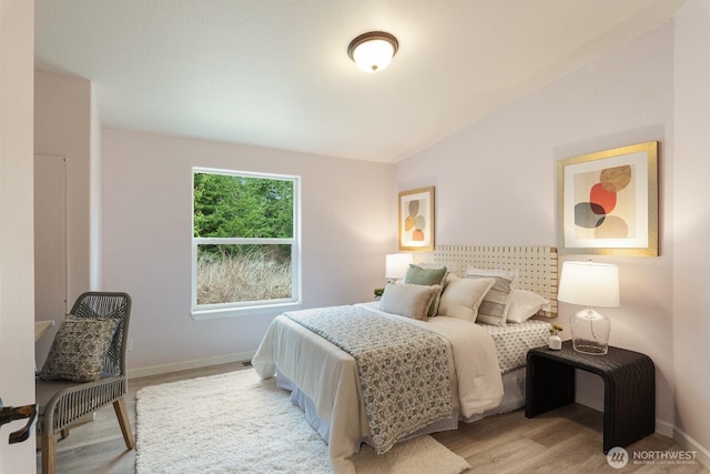 bedroom featuring baseboards and wood finished floors