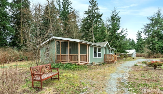 view of front facade with driveway and an outdoor structure