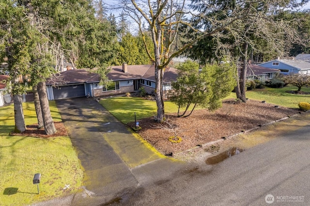 ranch-style house with a front yard, a garage, and driveway