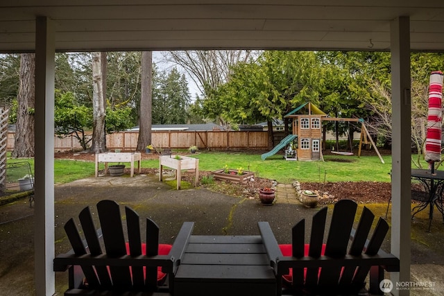 view of yard featuring a patio, a playground, and a fenced backyard